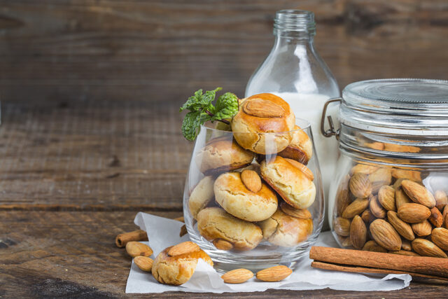 Homemade Almond cookies on a shabby wooden table background.